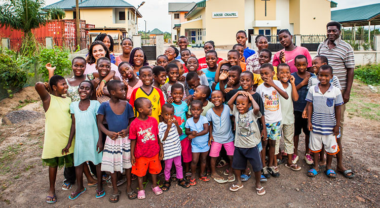 A large group of young African children with some Agape Global staff.